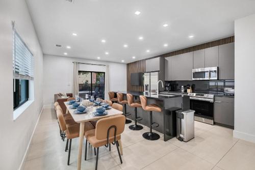 a kitchen and dining room with a table and chairs at Luxury Home with Inter Miami Theme in Miami