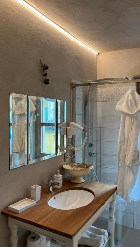 a bathroom with a sink and a mirror at La Casa di Paolo in Battifollo