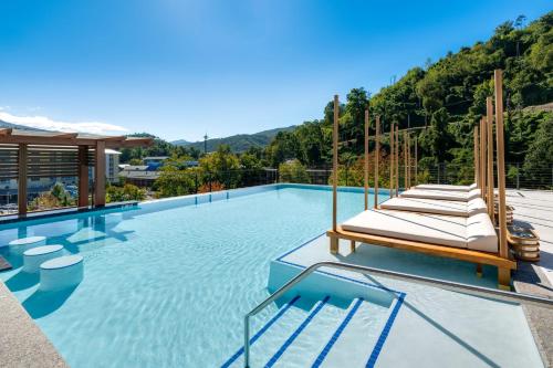 a swimming pool with a bunch of lounge chairs at Hotel Indigo Gatlinburg Downtown by IHG in Gatlinburg