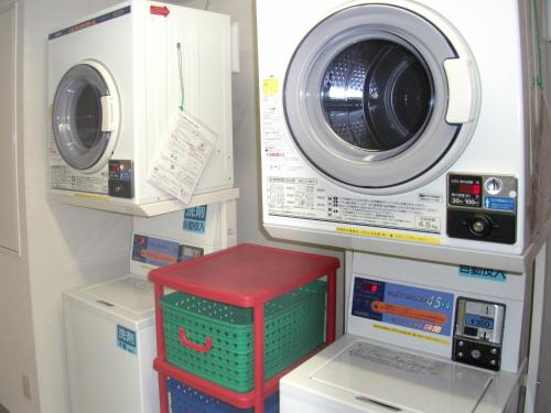 a laundry room with a washing machine and a washer at Smile Hotel Towada in Towada