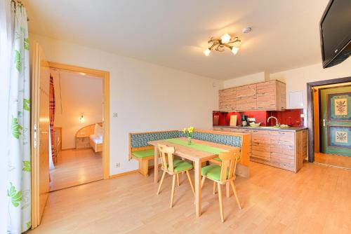 a kitchen and dining room with a table and chairs at Allesbauer - Familie Preis in Trebesing
