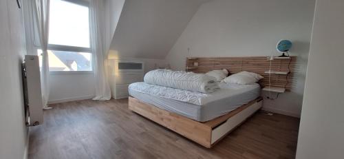een slaapkamer met een bed met een houten hoofdeinde bij Maison moderne à Baden in Baden