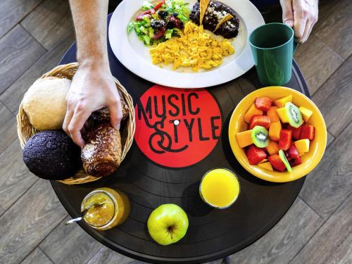 a table with plates of food on top of it at Ibis Styles Merida Galerias in Mérida