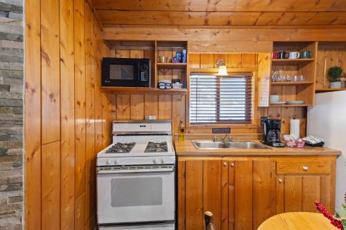 a kitchen with a stove and a sink at Cabin 4- One Bedroom cabin- RMNP in Estes Park