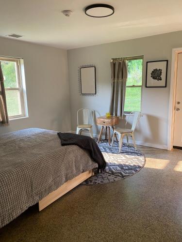 a bedroom with a bed and a table and chairs at The Holler in Andrews