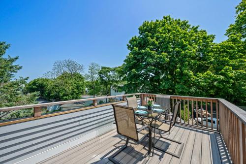 a patio with a table and chairs on a deck at Broadway in Rockport