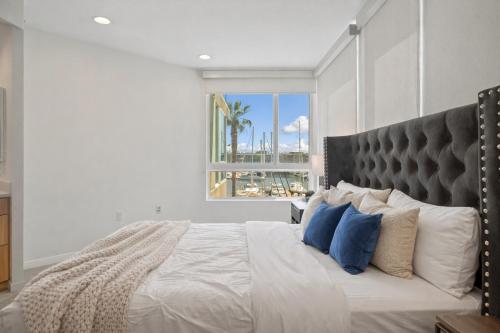 a bedroom with a large bed with blue pillows at Venice Marina Water Front Luxury Condo in Los Angeles