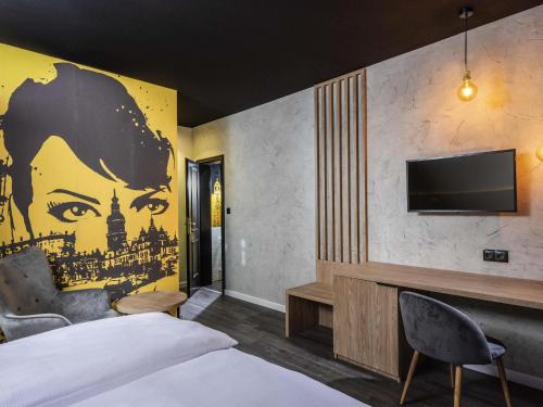 a hotel room with a wall mural of a woman at ibis Styles Dresden Neustadt in Dresden