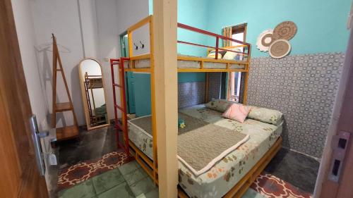 a bedroom with a bunk bed and a mirror at The Backyard Hostel in Yogyakarta