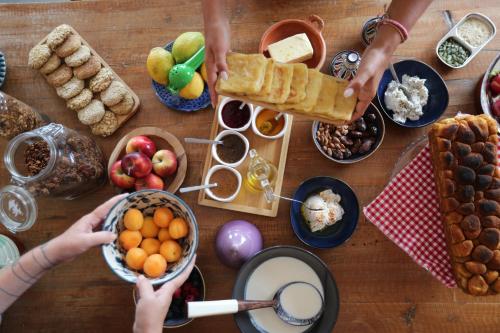 een groep mensen die elkaars handen vasthouden boven een tafel vol eten bij YMY Beach House in Agadir