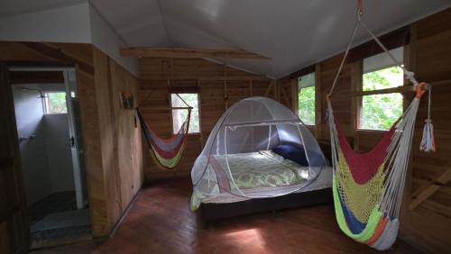 a room with a hammock in a house at Mombacho Lodge in Granada