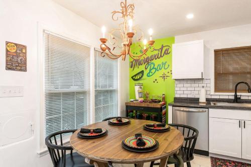 a kitchen with a wooden table and chairs in a kitchen at La Casa Bella 5BR 3BA Games 2 Living Areas in Louisville