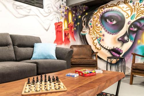 a living room with a couch and a chess board on a table at La Casa Bella 5BR 3BA Games 2 Living Areas in Louisville
