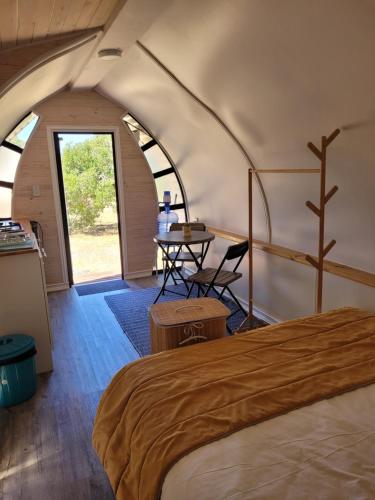 a bedroom in a dome tent with a bed and a table at Achibueno Glamping in Linares