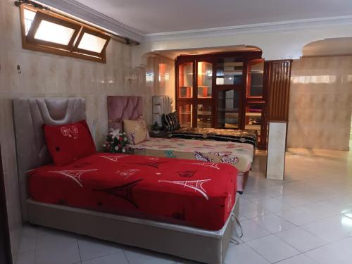 a bedroom with two beds and a couch at Villa Hay Riad - Harhoura in Temara