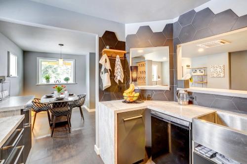 a kitchen with a table and a dining room at 'Little House on the Lot' Dryden Townhome: Pets OK in Dryden