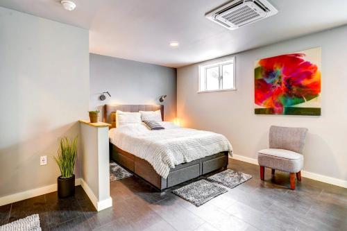 a bedroom with a bed and a chair at 'Little House on the Lot' Dryden Townhome: Pets OK in Dryden