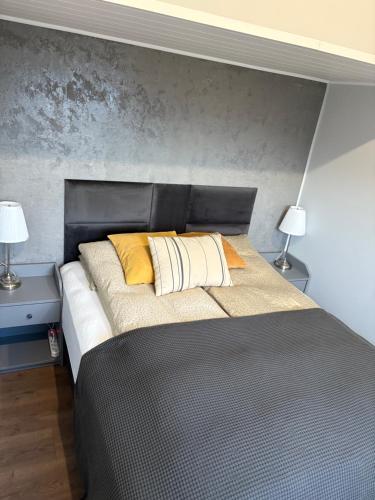 uma cama com dois travesseiros em um quarto em Brim Guesthouse, with ocean view em Sauðárkrókur