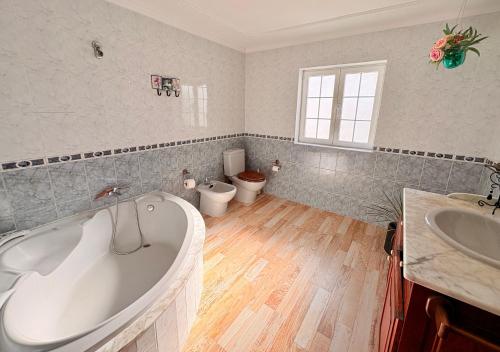 a bathroom with a tub and a sink and a toilet at myplace in Tiagua