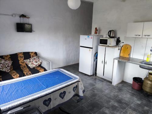a kitchen with a table in the middle of a room at La casa de Juan in Cuchilla Alta