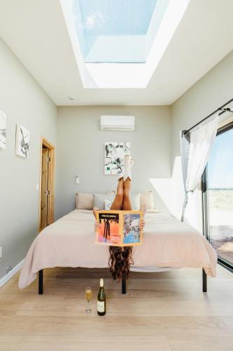 a bedroom with a bed with a skylight at Grand Canyon Stargazing Off-Grid in Williams