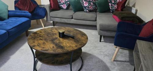 a coffee table with a remote control on it in a living room at Work & Family Haven - Ashford in Ashford