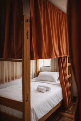two bunk beds in a room with a window at Shanti Hotel Pisac in Pisac