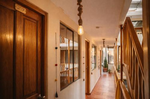 a hallway of a house with wooden doors at Shanti Hotel Pisac in Pisac