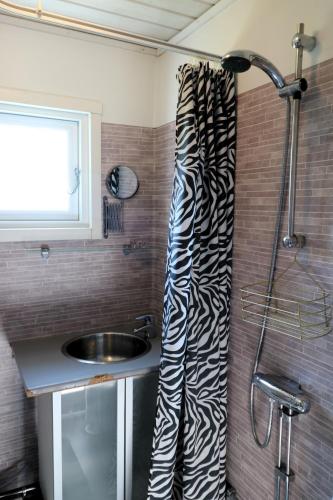 a bathroom with a sink and a shower curtain at Aurora Jukkasjarvi in Jukkasjärvi
