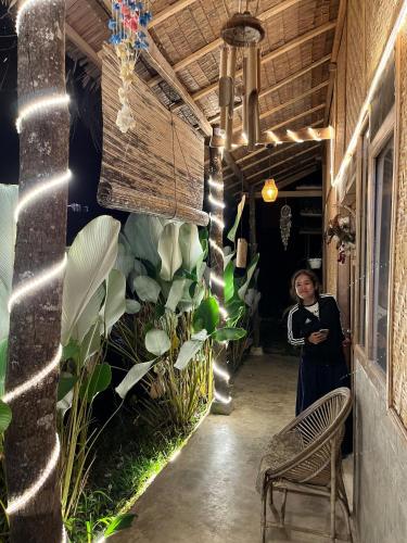 a woman standing in the hallway of a building at rk.homestay in Rantepao