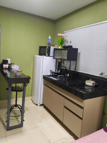 a kitchen with a counter top and a refrigerator at Flats containers 303 in Rio Verde