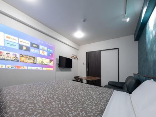 a hotel room with a bed and a tv at Hote Io Lite in Nago