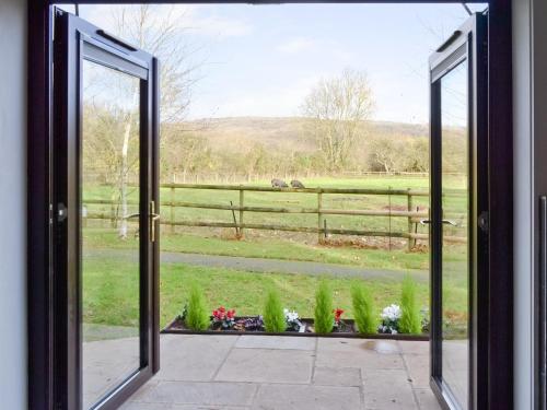 an open door with a view of a field at Blackberry Lodge in Cheddar