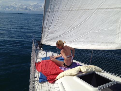 a woman sitting on the deck of a boat at Cavallino House Boat in Cavallino-Treporti
