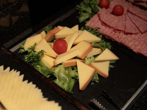 a tray of cheese and vegetables on a table at Mercure Tallinn in Tallinn