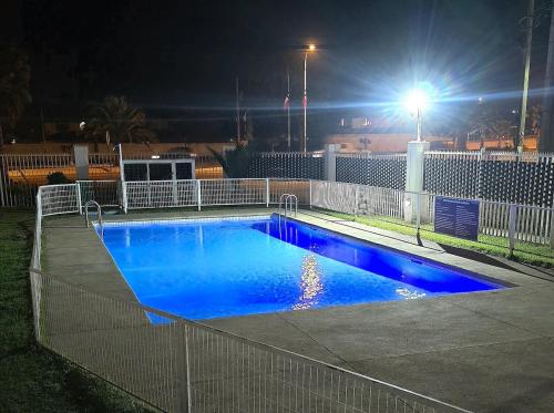 a swimming pool with blue water at night at Oceanfront Vacation Pool WiFi Parking in Coquimbo