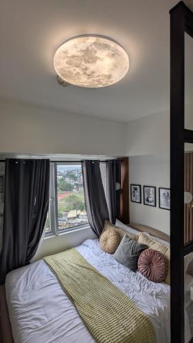a bedroom with a large bed with a window at Vinyce Studio in Cagayan de Oro