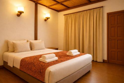 een slaapkamer met een bed met twee handdoeken erop bij Redang Divers Resort in Redang Island