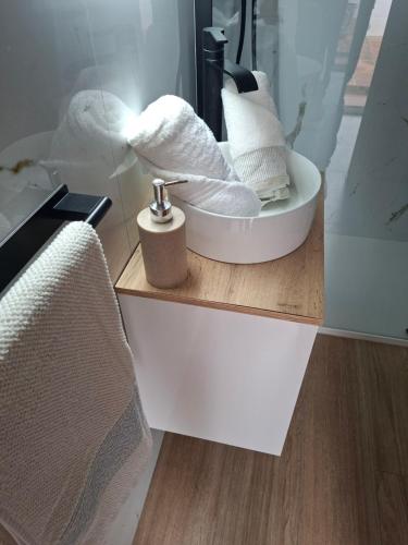 a bathroom with a sink with towels and a mirror at CASA PERSEA in Nerja