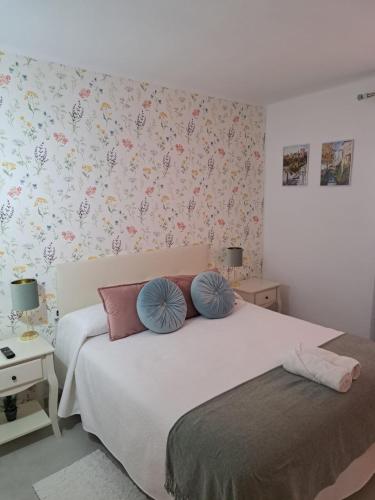 a bedroom with a bed with two pillows on it at CASA PERSEA in Nerja