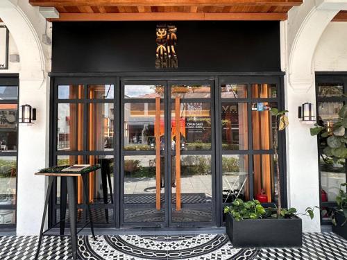 an entrance to a building with a glass door at Magazine Vista Hotel Managed by The Ascott Limited in George Town