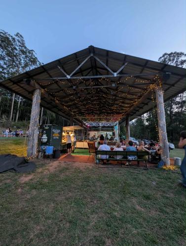 a group of people sitting on benches under a pavilion at Soulhaven at Bentley in Bentley