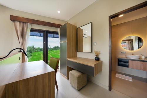 a bathroom with a vanity and a sink and a mirror at Uma Dauh Villa - Cemagi in Munggu