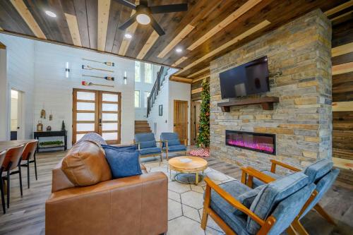 a living room with a couch and a fireplace at Chillax Inn The River For 19 in Broken Bow