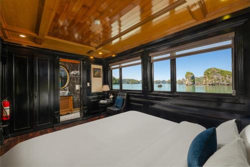 a bedroom with a bed and a view of the water at Beka Cruise in Cat Ba
