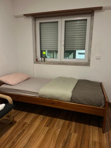 a large bed in a room with a window at MALÔ - Queluz in Queluz