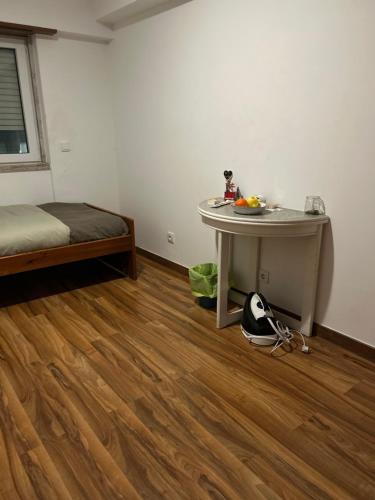 a room with a table and a bed and a table at MALÔ - Queluz in Queluz