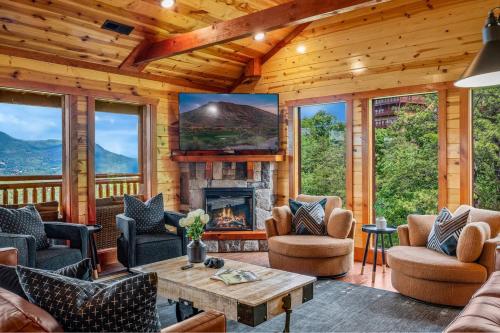 a living room with a fireplace in a log cabin at Soaring Views Lodge in Sevierville
