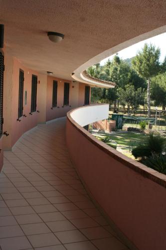 an empty hallway of a building with a walkway at Verdemare Sardegna Uno in Villasimius
