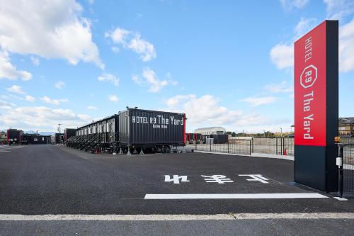 a train car is parked in a parking lot at HOTEL R9 The Yard Gamohino in Hino
